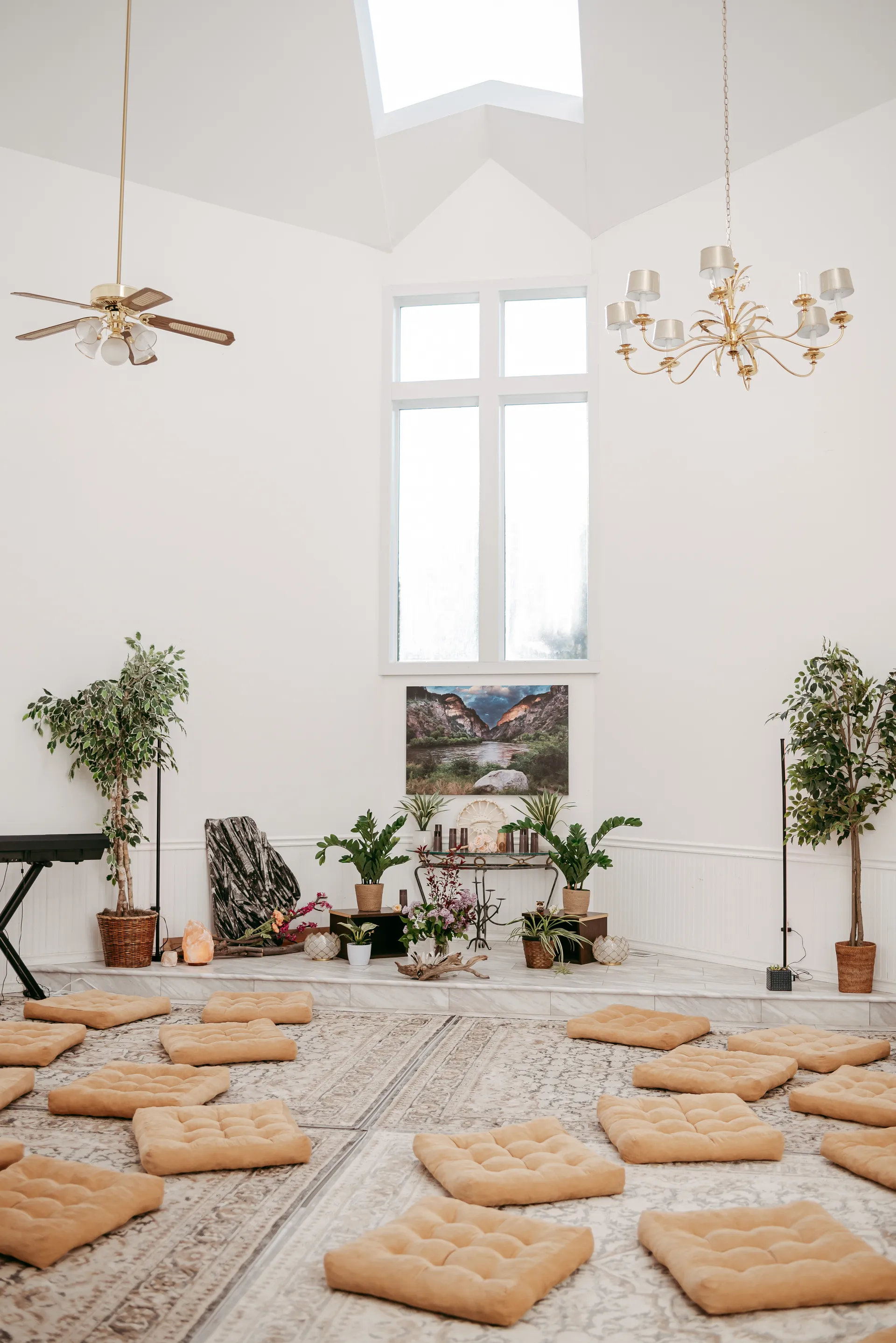Sunlit ceremony hall with vaulted ceilings and meditation cushions arranged in a circle