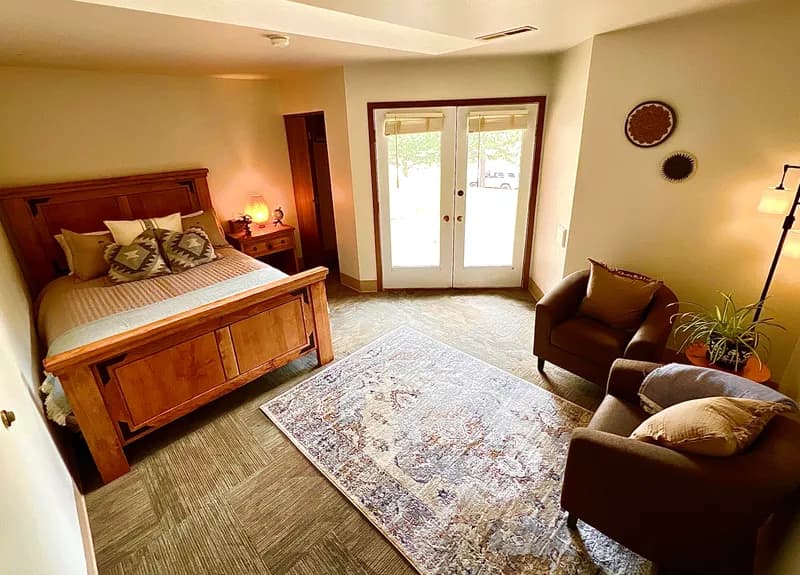 Private retreat room with wooden bed frame and warm lighting