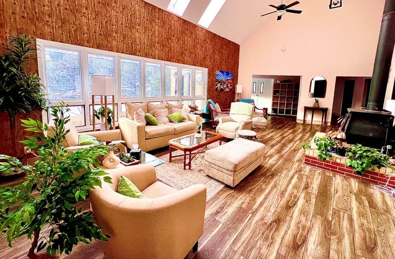 Open lounge area with vaulted ceilings and natural light
