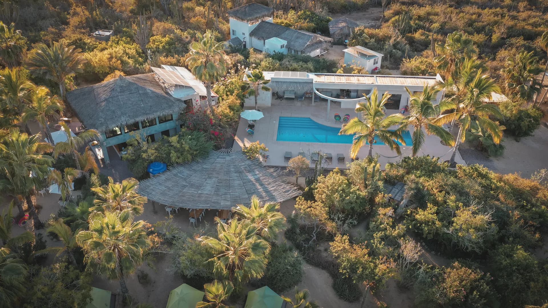 Outdoor pool surrounded by ocean and desert horizon at the Ceremonia Baja California retreat