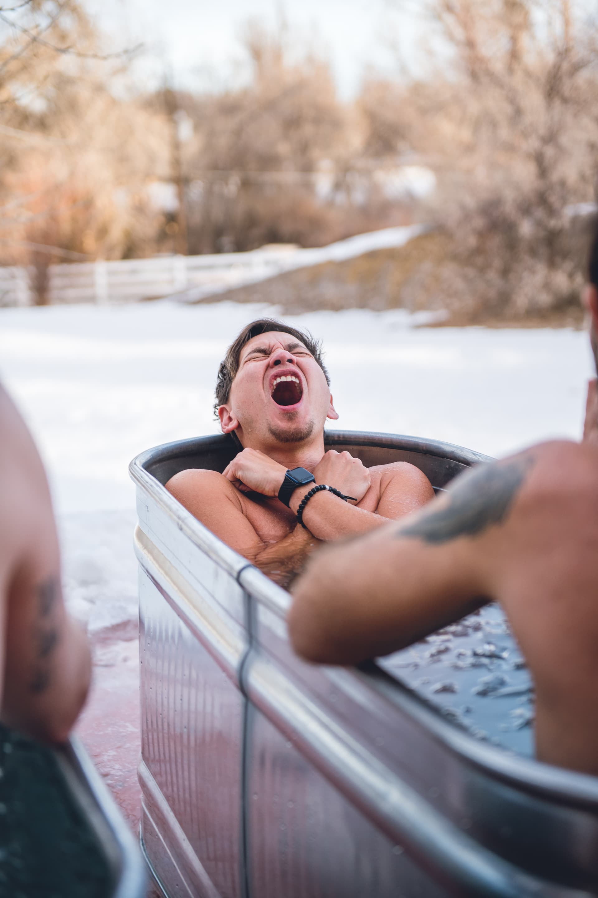 A man in a hot tub with his mouth open.