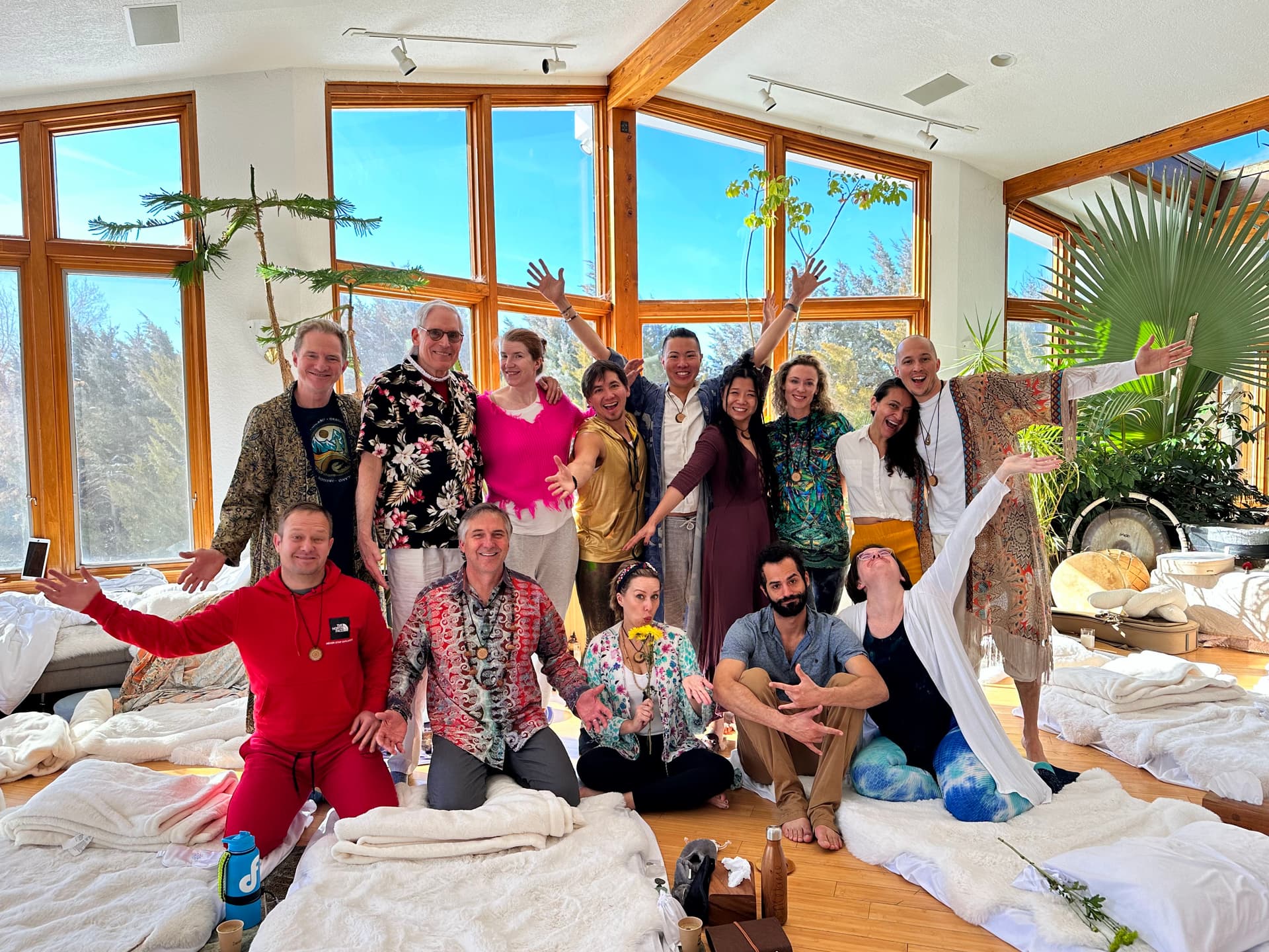 A group of people standing in a room retreat circle a group of friends.